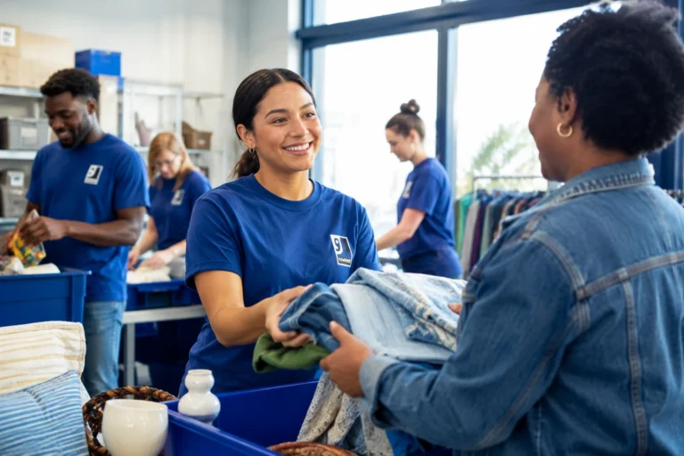 A clothing donation being received at a Goodwill counter.